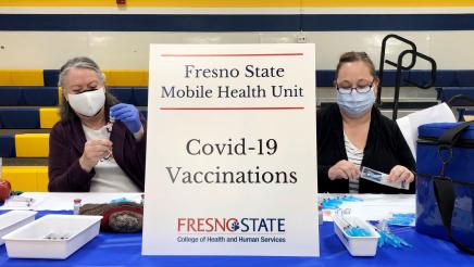 Volunteers prepare COVID-19 vaccines for a clinic offered by Assemblymember Dr. Joaquin Arambula and partners at Laton High School on March 2, 2021.