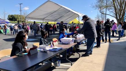 People wait in long lines for second doses of COVID-19 vaccinations in Biola on March 23, 2021. The clinic was one in a series that Assemblymember Dr. Joaquin Arambula and partners offered in 2021. Partners included the Fresno State Mobile Health Unit, Saint Agnes Medical Center, and Cultiva La Salud.