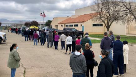 People wait in a long line for COVID-19 vaccinations in Orange Cove on February 9, 2021. The clinic was one in a series that Assemblymember Dr. Joaquin Arambula and partners offered in 2021. Partners included the Fresno State Mobile Health Unit, Saint Agnes Medical Center, and Cultiva La Salud.