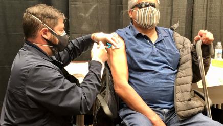 Assemblymember Dr. Joaquin Arambula administers a COVID-19 vaccine during a clinic held at the Central Valley Regional Center in Fresno to inoculate people with disabilities on February 27, 2021.