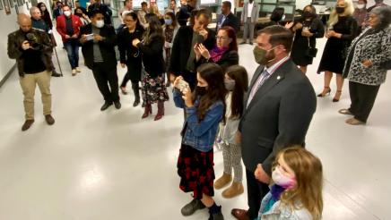 Ceremony attendees join Assemblymember Arambula and his family to view his photo joining the photos of past Ohtli Award honorees at the Consulate of Mexico in Fresno.