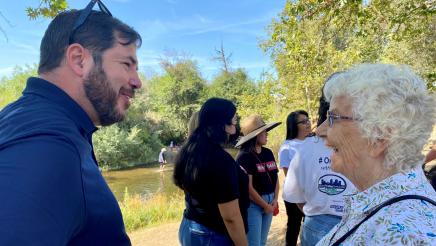 Assemblymember Dr. Joaquin Arambula talks with a parkway supporter at the July 23, 2021 event announcing the $15 million State allocation to the San Joaquin River Conservancy for operations and land maintenance of the parkway.