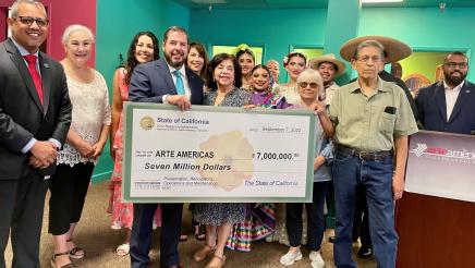 Assemblymember Arambula stands with other elected officials and Arte Américas board members and supporters, displaying the State check for the cultural arts center.