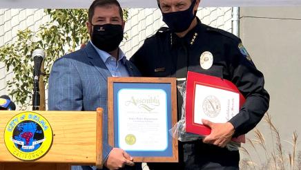 Assemblymember Dr. Joaquin Arambula presents a certificate in recognition of the opening of the new Selma Police headquarters to Selma Police Chief Joe Gomez.