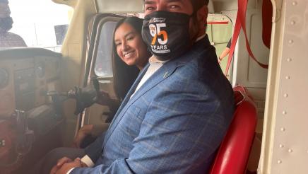 Assemblymember Arambula and Annalisa Perea, a trustee on the SCCCD Governing Board, sit in the cockpit of plane in the Reedley College Aeronautics Building.