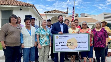 Assemblymember Dr. Joaquin Arambula stands with seniors who participate in activities at the current senior center in Fowler.