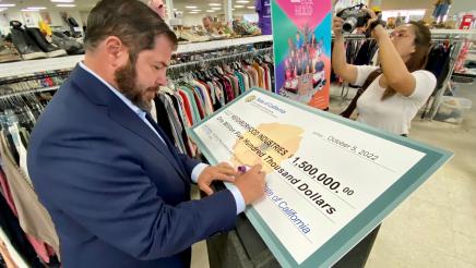 Assemblymember Dr. Joaquin Arambula signs the check representing $1.5 million in State funds that he secured for Neighborhood Industries of Fresno.