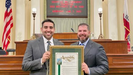 Matias Bernal, Executive Director of the Education and Leadership Foundation, and Assemblymember Dr. Joaquin Arambula hold a State Resolution proclaiming ELF as the 2023 Nonprofit of the Year for the 31st District. They are on the Assembly floor in the State Capitol. The presentation was made June 7, 2023.
