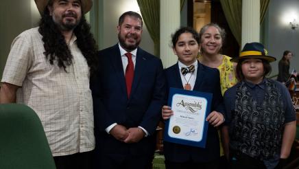 Assemblymember Dr. Joaquin Arambula and honoree Malachi Suarez are seen with Malachi’s family in the Assembly chambers on Aug. 17, 2023, after Assemblymember Arambula recognized Malachi during the Assembly session. 