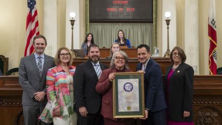 Assemblymember Dr. Joaquin Arambula presents Genoveva “Veva” Islas as the 2023 Woman of the Year for the 31st Assembly District. They are seen here at the State Capitol with (from left) Assembly Minority Leader James Gallagher, Assembly Majority Leader Eloise Gomez Reyes, Assembly Speaker Anthony Rendon, and Assemblymember Cecilia Aguiar-Curry, vice chair of the California Legislative Women’s Caucus.